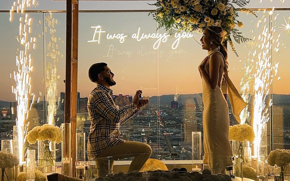 outdoor wedding proposal las vegas strip view rooftop balcony with sparkler fountain and neon it was always you sign at sunset